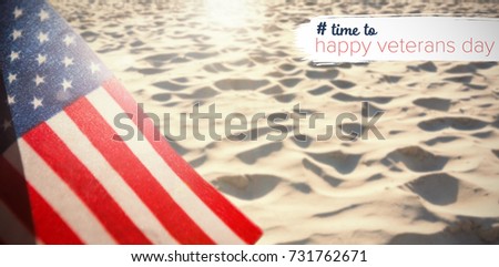 Logo for veterans day in america hashtag against surface of rippled sand