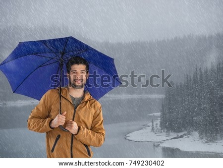 Digital composite of Man with umbrella and snow forest