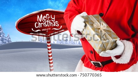Digital composite of Merry Christmas text and Santa holding gifts with Wooden signpost in Christmas Winter landscape