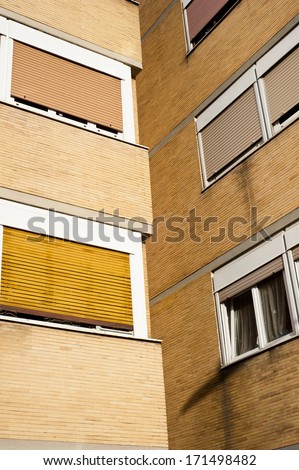 two buildings face each other with their shutters down