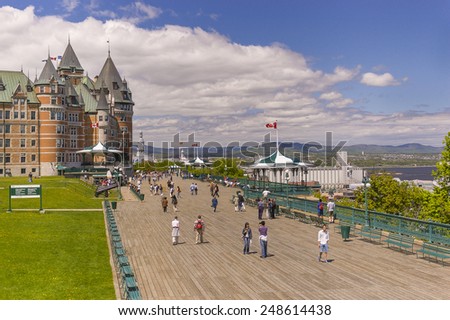 QUEBEC CITY, QUEBEC, CANADA - MAY 31, 2004: Le Chateau Frontenac castle and hotel, with people walking along Dufferin Terrace boardwalk, a National Historic Site, in Old Quebec City.
