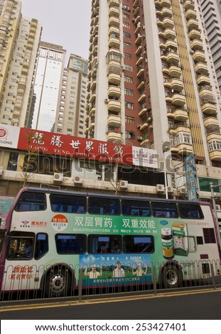 SHENZHEN, GUANGDONG PROVINCE, CHINA - OCTOBER 13, 2006: Double-decker bus and buildings, in city of Shenzhen.