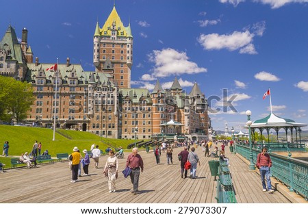 QUEBEC CITY, QUEBEC, CANADA -  MAY 30, 2004: Le Chateau Frontenac castle and hotel, with people walking along Dufferin Terrace boardwalk, a National Historic Site, in Old Quebec City.