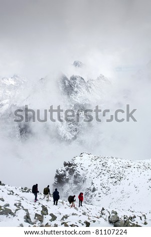 climbing to mountain peak Rysy Slovakia Vysoke Tatry, July snow