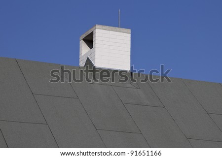 new white chimney on the asphalt roof,