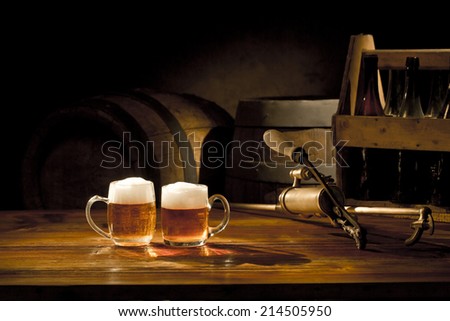 beer still life on the table with old keg of beer and tap