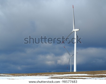 wind power station with cloudy sky