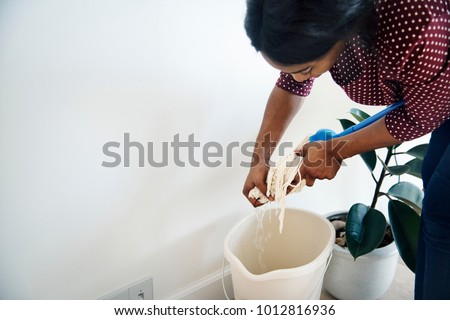 Black woman cleaning room