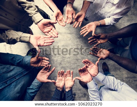 Group of diverse hands palms circle support together teamwork aerial view