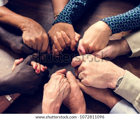 Group of diverse hands holding each other support together teamwork aerial view