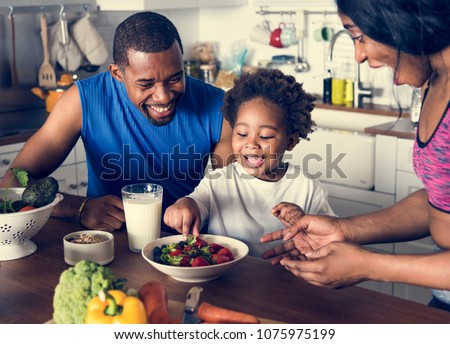 Black family eating healthy food together