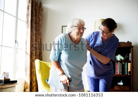 Nurse helping senior woman to stand