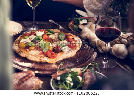 Homemade pizza for dinner with red wine