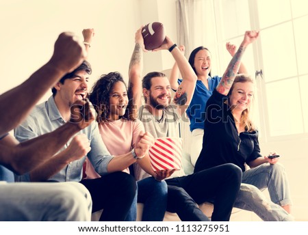 Friends cheering sport league together