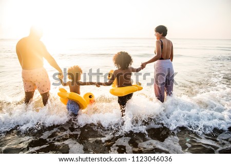 Black family having fun on the beach