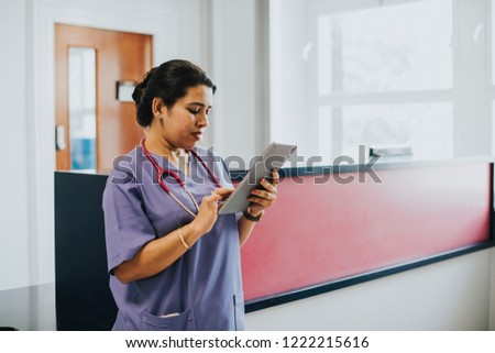 Female nurse checking the schedule on a tablet