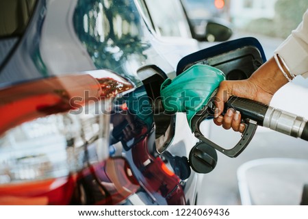 Man filling up gas in his car