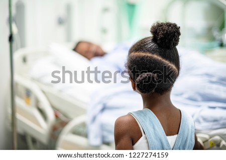 Daughter watching her grandmother sleep at the hospital