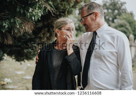 Husband trying to comfort his wife due to her loss