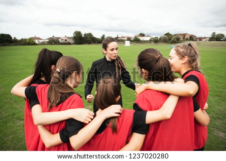 Rugby players and their coach gathering before a match