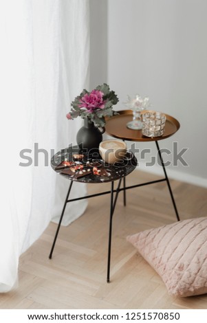 Dark chocolate brittle and milk tea on a black table with an ornamental kale flower