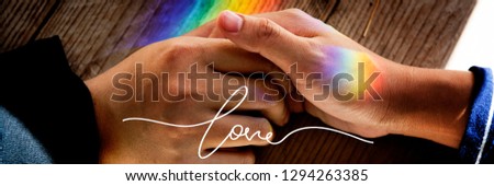 Couple holding hands with shadows prism light
