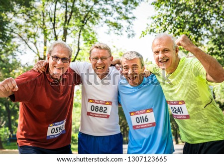 Group of cheerful senior runners at the park
