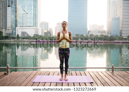 Black lady making a meditation at a park