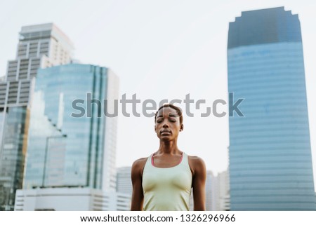 Black lady making a meditation at a park