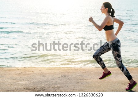 Active woman jogging by the sea in the morning