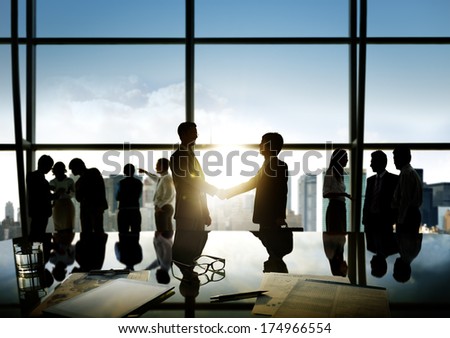 Group Of Business People And Men Handshake Reflected Onto Table With Documents.
