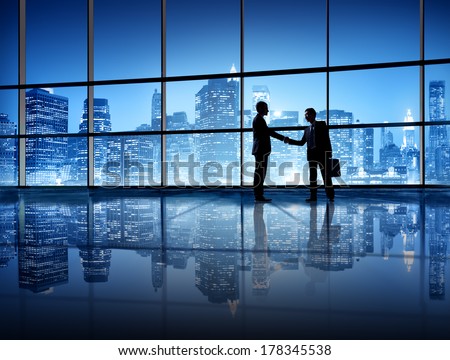 Business Handshake with City Skyline