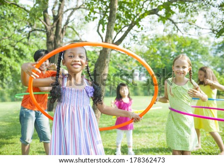 Children Playing with Hula Hoops in Park