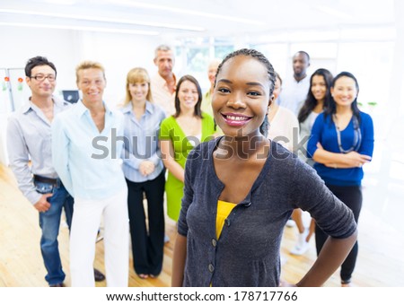 Beautiful Young African Woman Standing Out of the Crowd in Office