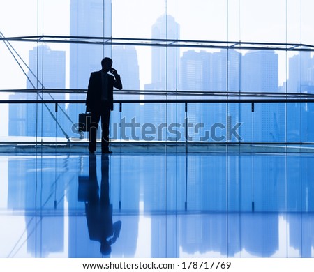 Silhouette of Businessman on the Phone in City Office