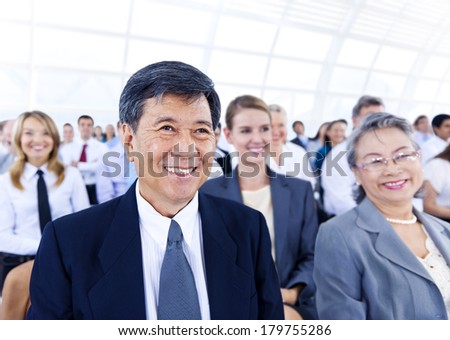 Senior Asian Businessman in Large Seminar