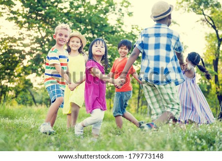 Diverse Children Holding Hands and Dancing in The Park