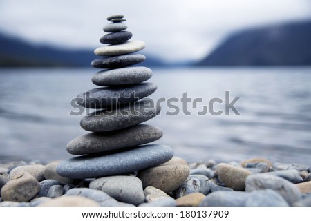 Zen Balancing Rocks Next to a Misty Lake, New Zealand