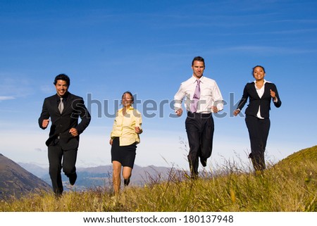 Business People Running Up a Hill