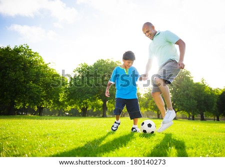 Father and Son Playing Ball in The Park