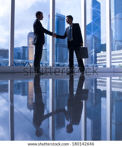 Western and Chinese Businessmen Shaking Hands in Hong Kong