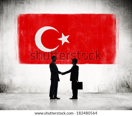 Two Businessmen Shaking Hands With Flag of Turkey
