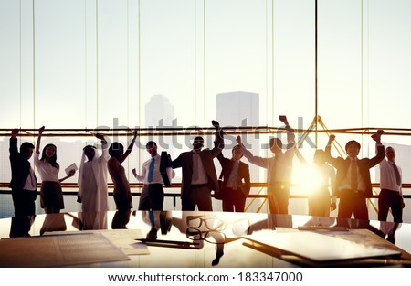 Multi-Ethnic Group Of Business People Celebrating In Board Room