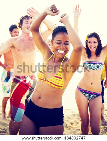 Group of people partying on the beach.