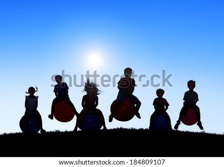 Silhouettes of Children Playing on Bouncy Balls