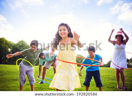 Whole family hula hooping outdoors.