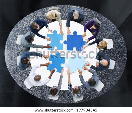 Business People with Puzzle Pieces and Teamwork Concept