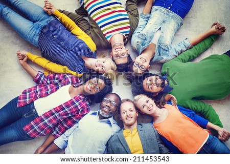 Multiethnic Group of People Holding Hands and Lying Down