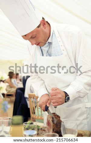 Chef carving beef at a wedding reception.