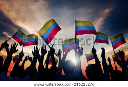 Group of People Waving Colombian Flags in Back Lit